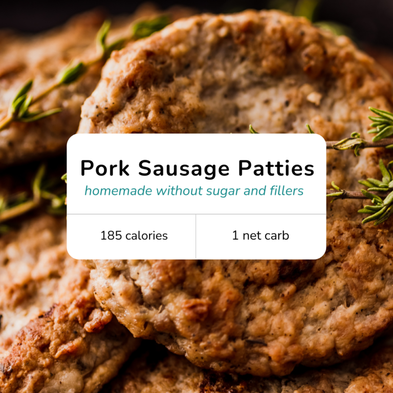 Close-up of homemade pork sausage patties stacked on a plate with browned edges and fresh herbs.